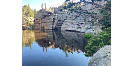 People sitting beside Gem Lake