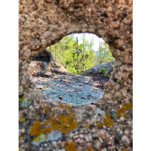 Photo taken through a hole in a boulder on the trail