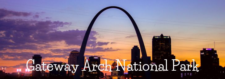 The Gateway Arch against an orange and purple sunrise