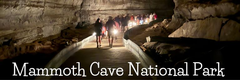 Tourists holding lanterns on a tour inside Mammoth Cave National Park